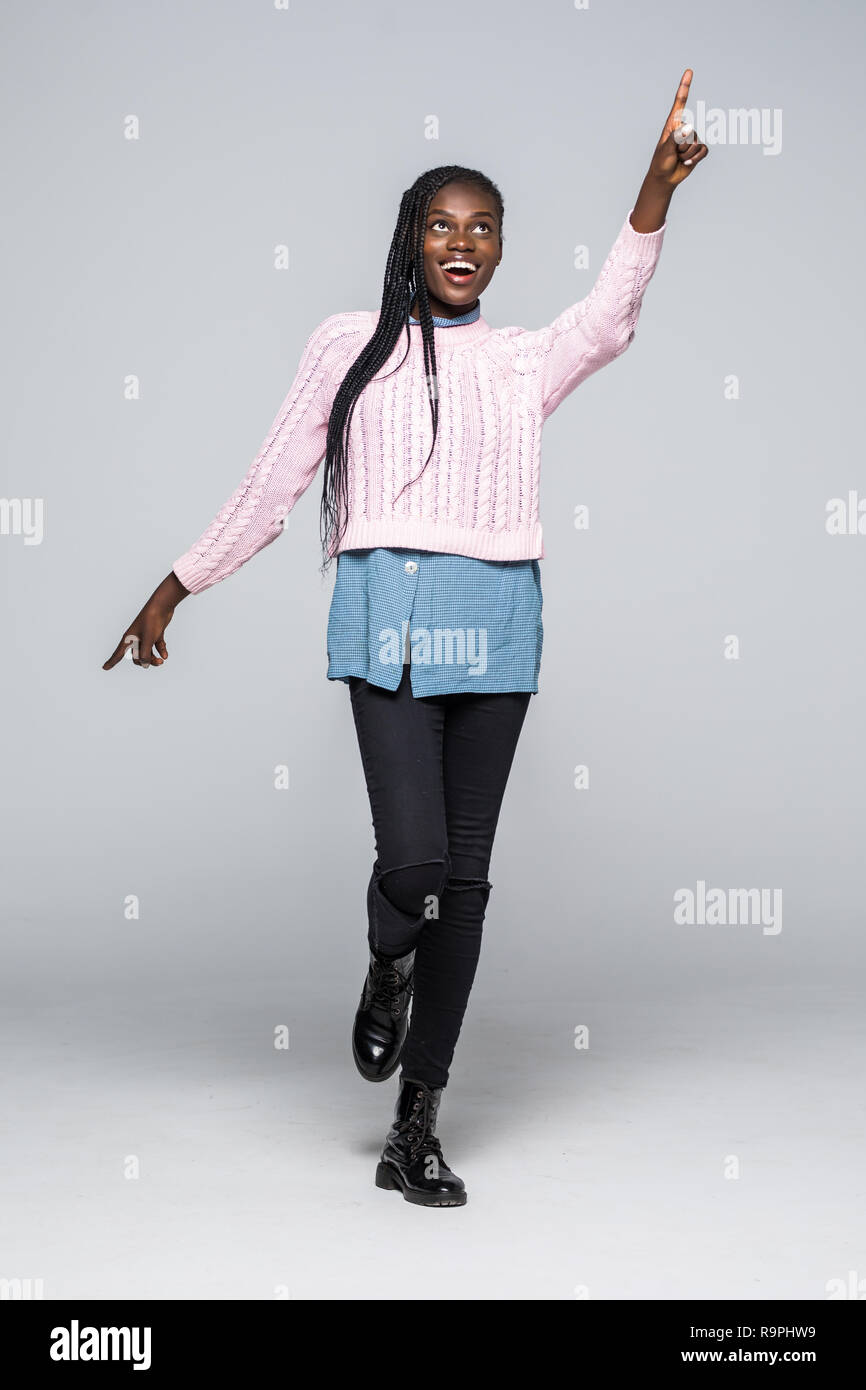 Full length portrait of a happy young african woman jumping and ...
