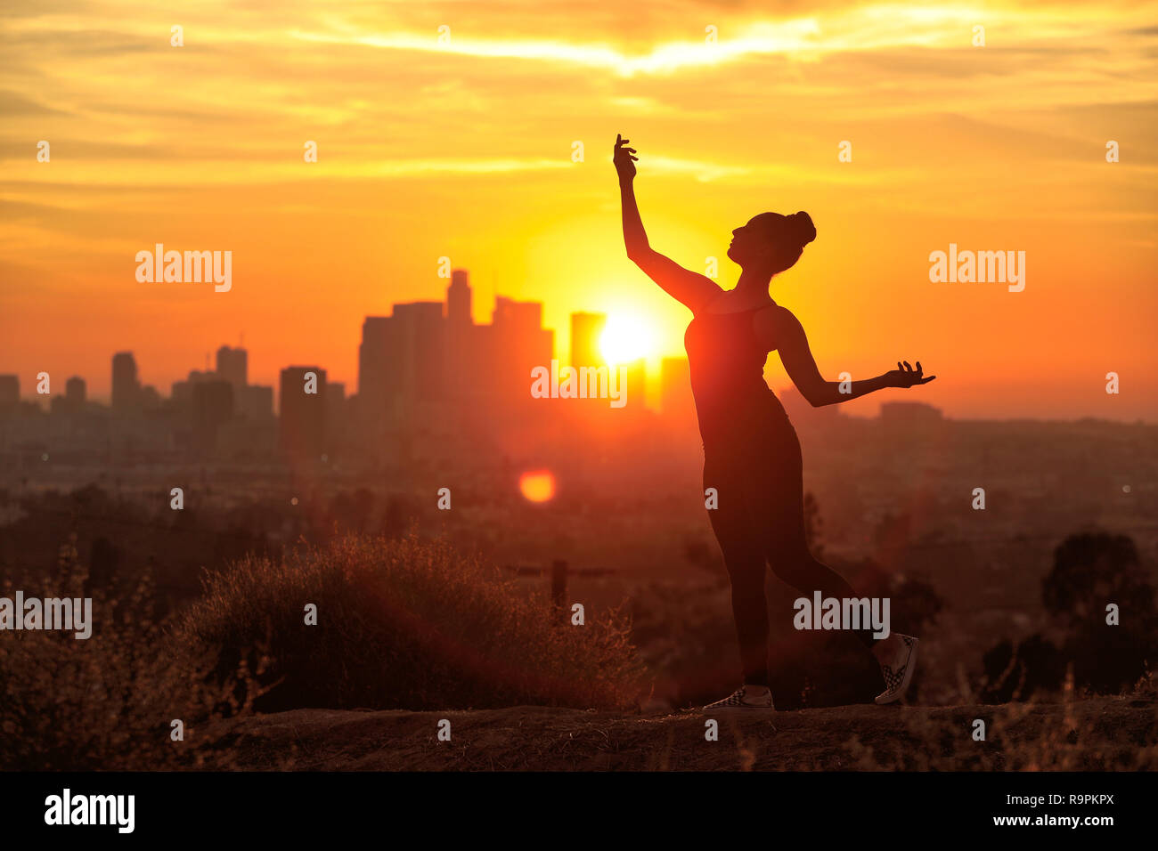 Silhouette of a Woman Posing at Sunset in Los Angeles California Stock Photo