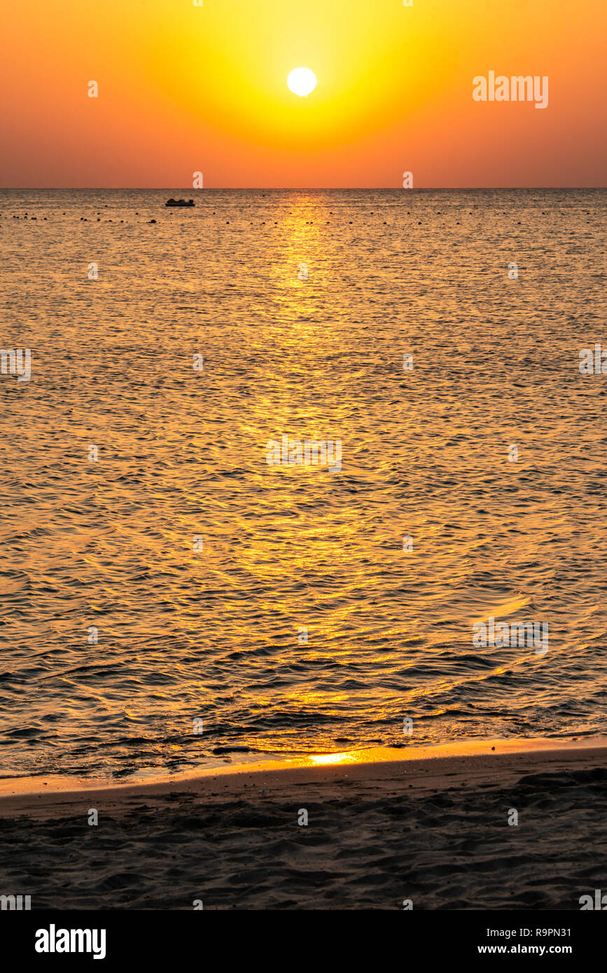 boat silhouetts on the shores of the red sea at sunset in Makadi Bay ...