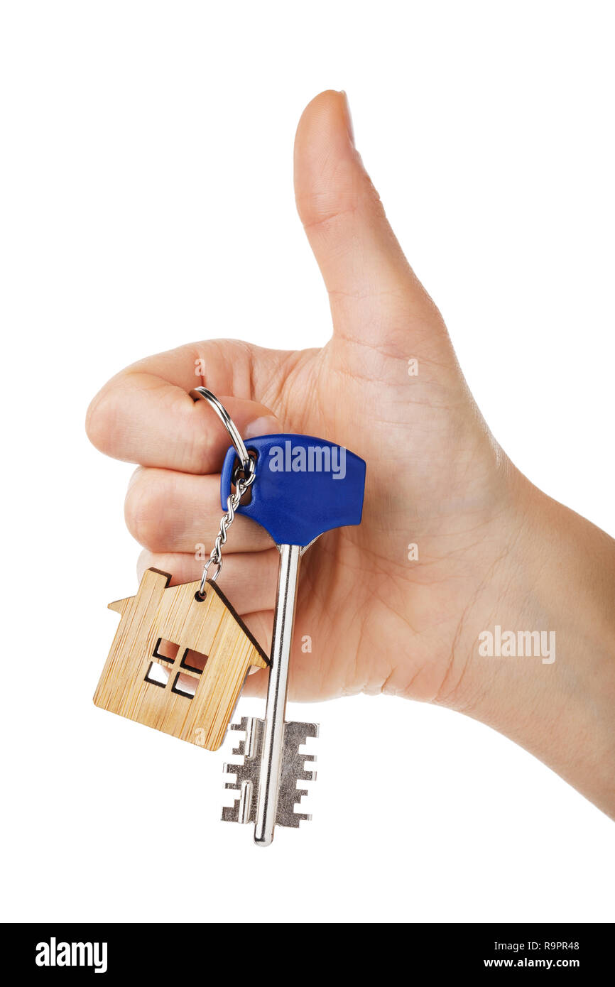 House keys in hand isolated on white background. Thumb gesture showing that everything is fine Stock Photo