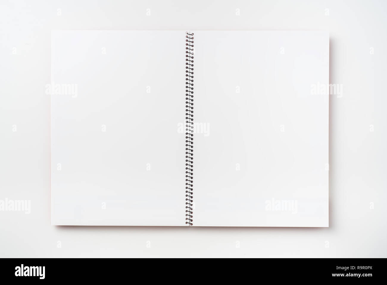 Design concept - Top view of  spiral notebook white page isolated on background for mockup Stock Photo