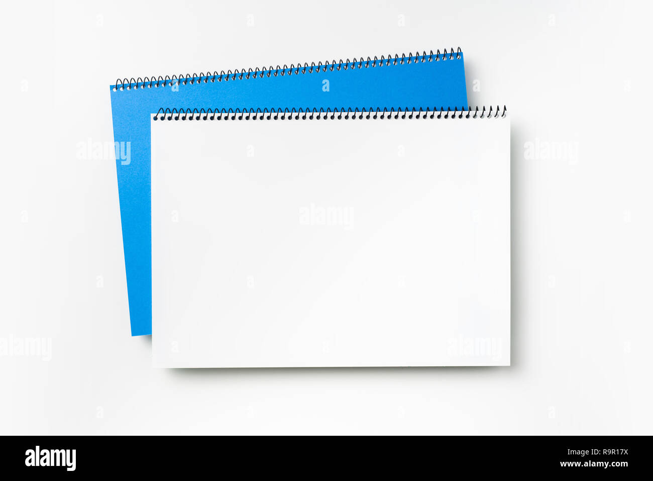 Design concept - Top view of blue spiral notebook and pencil isolated on background for mockup Stock Photo