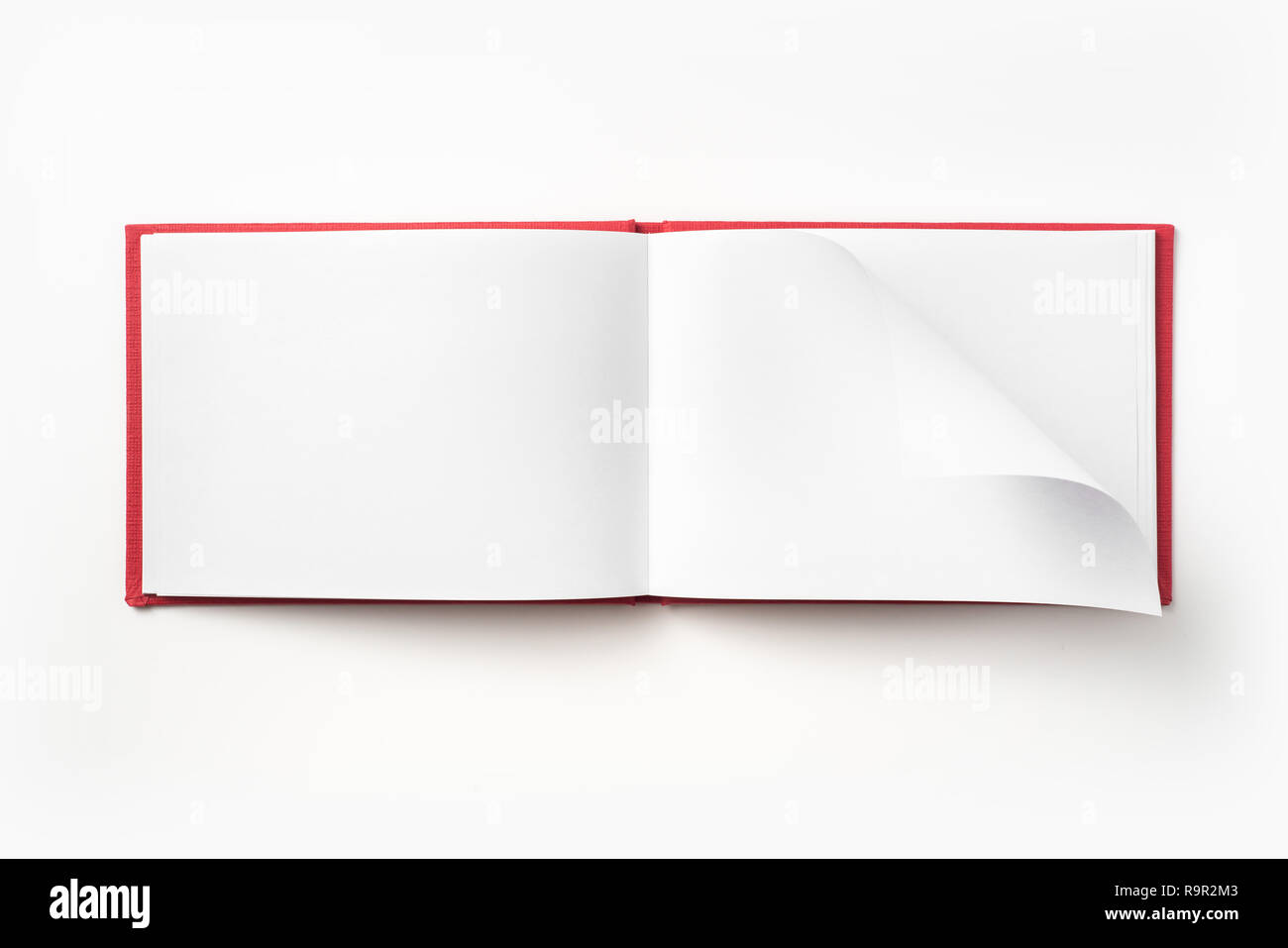 Design concept - Top view red hardcover notebook with open & flip curl rolled page isolated on background for mockup Stock Photo