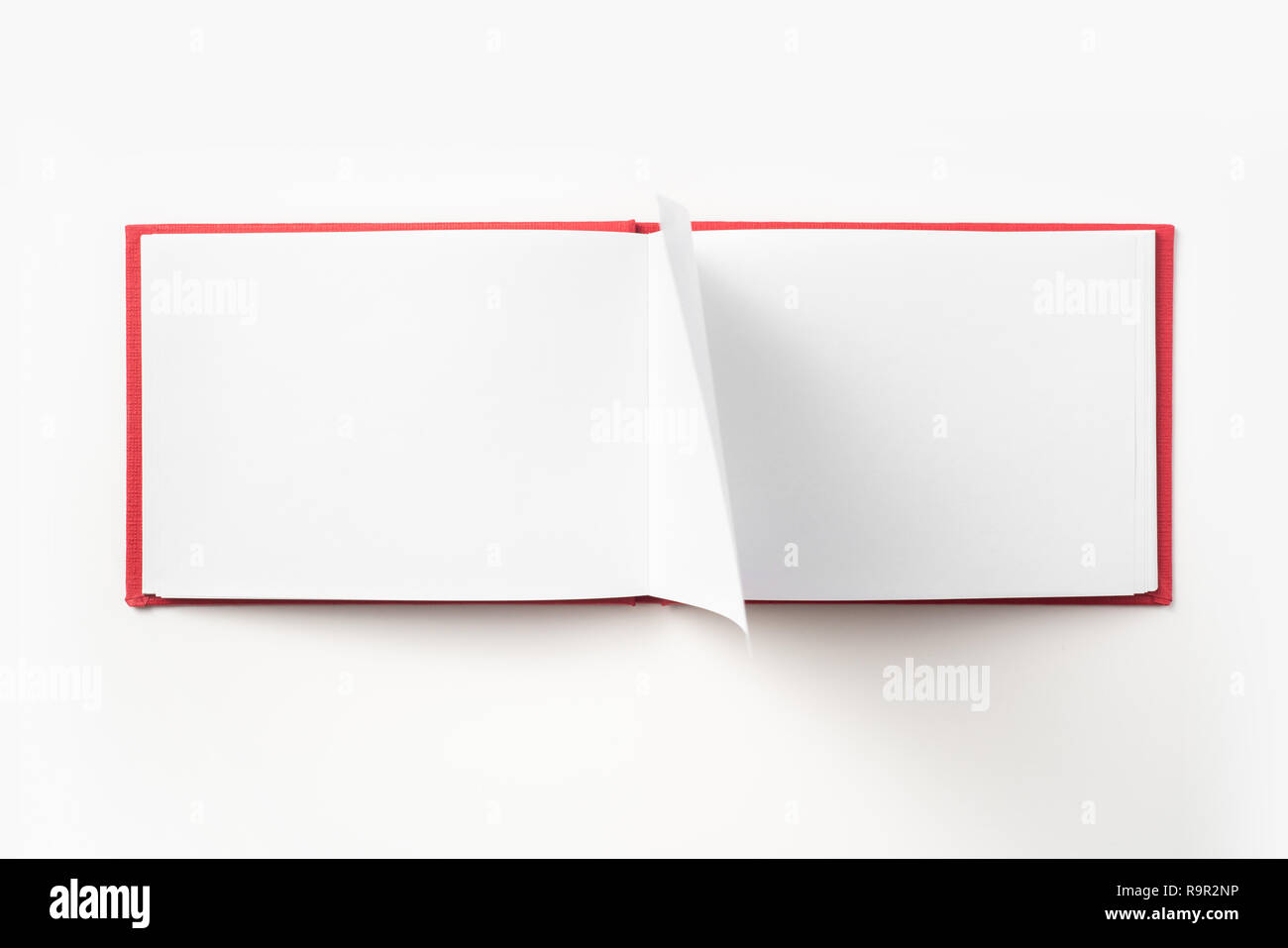 Design concept - Top view red hardcover notebook with open & flip curl  rolled page isolated on background for mockup Stock Photo - Alamy