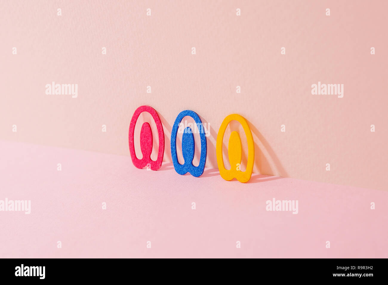 Red & Blue & Yellow Clips. Pink Two Tone Background. Stock Photo