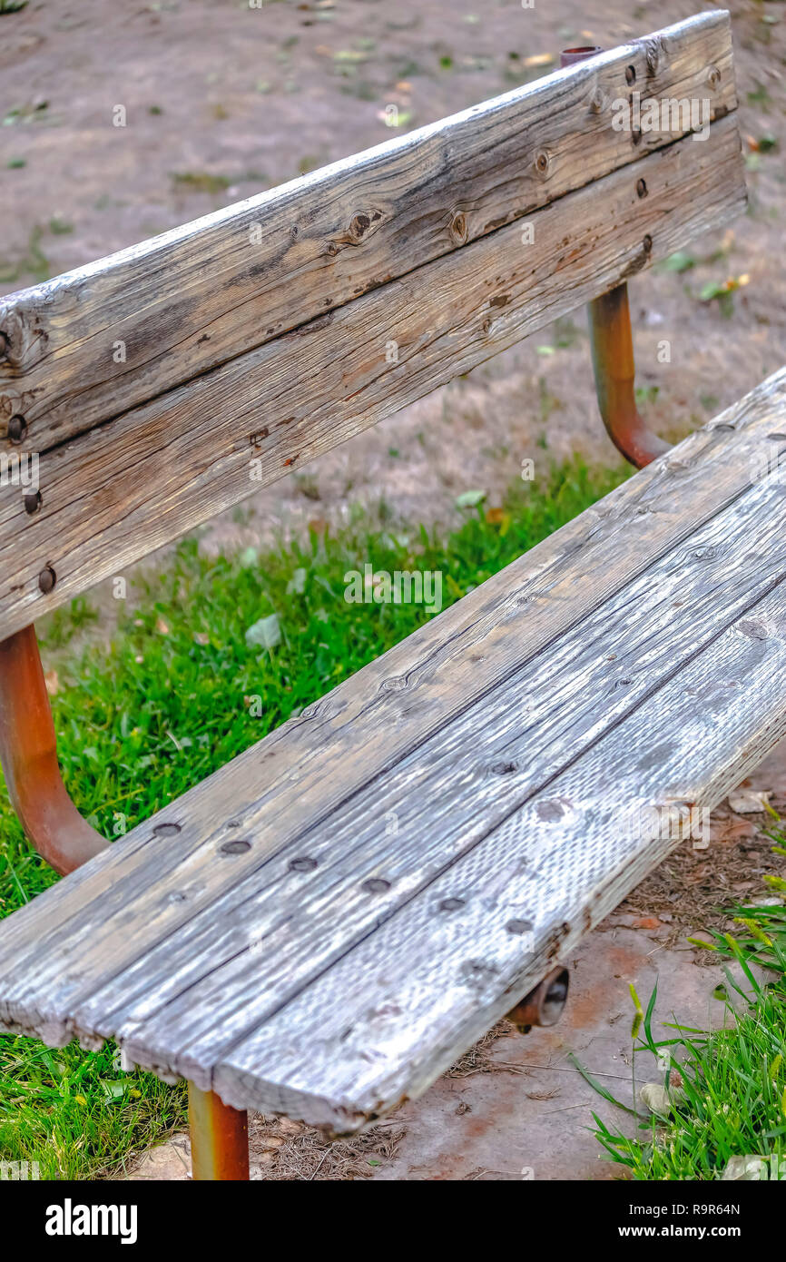 Weathered wooden bench with rusting metal support Stock Photo Alamy