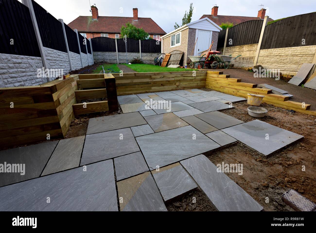 Indian paving slabs being laid on a garden patio garden renovation UK Stock Photo