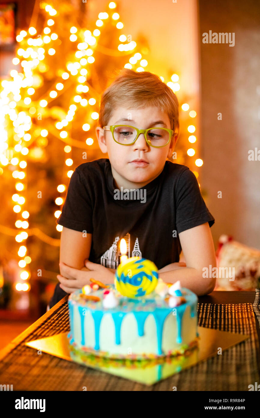 Beautiful adorable six year old boy in grey shirt, celebrating his