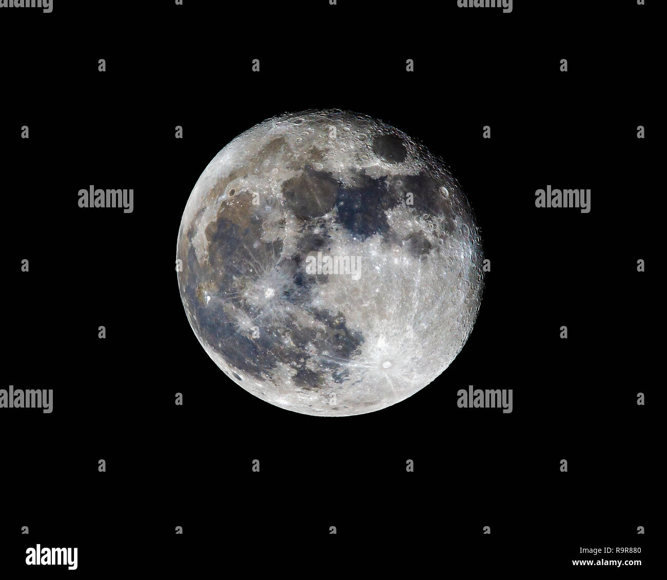 Waning gibbous Moon viewed from south-east England, UK processed to reveal true colours, various craters and mare visible Stock Photo