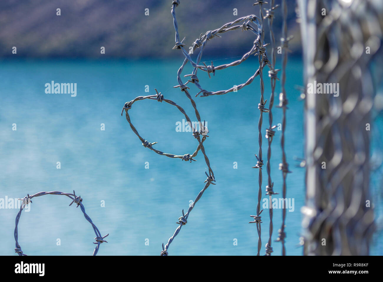 barbed wire fence for protection at Lake Coleridge, New Zealand Stock