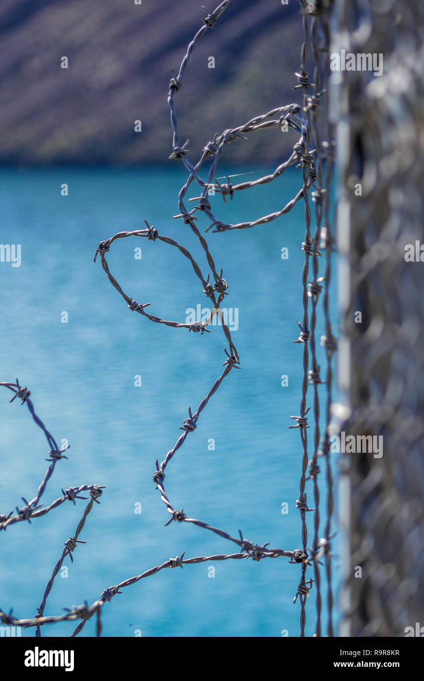 barbed wire fence for protection at Lake Coleridge, New Zealand Stock