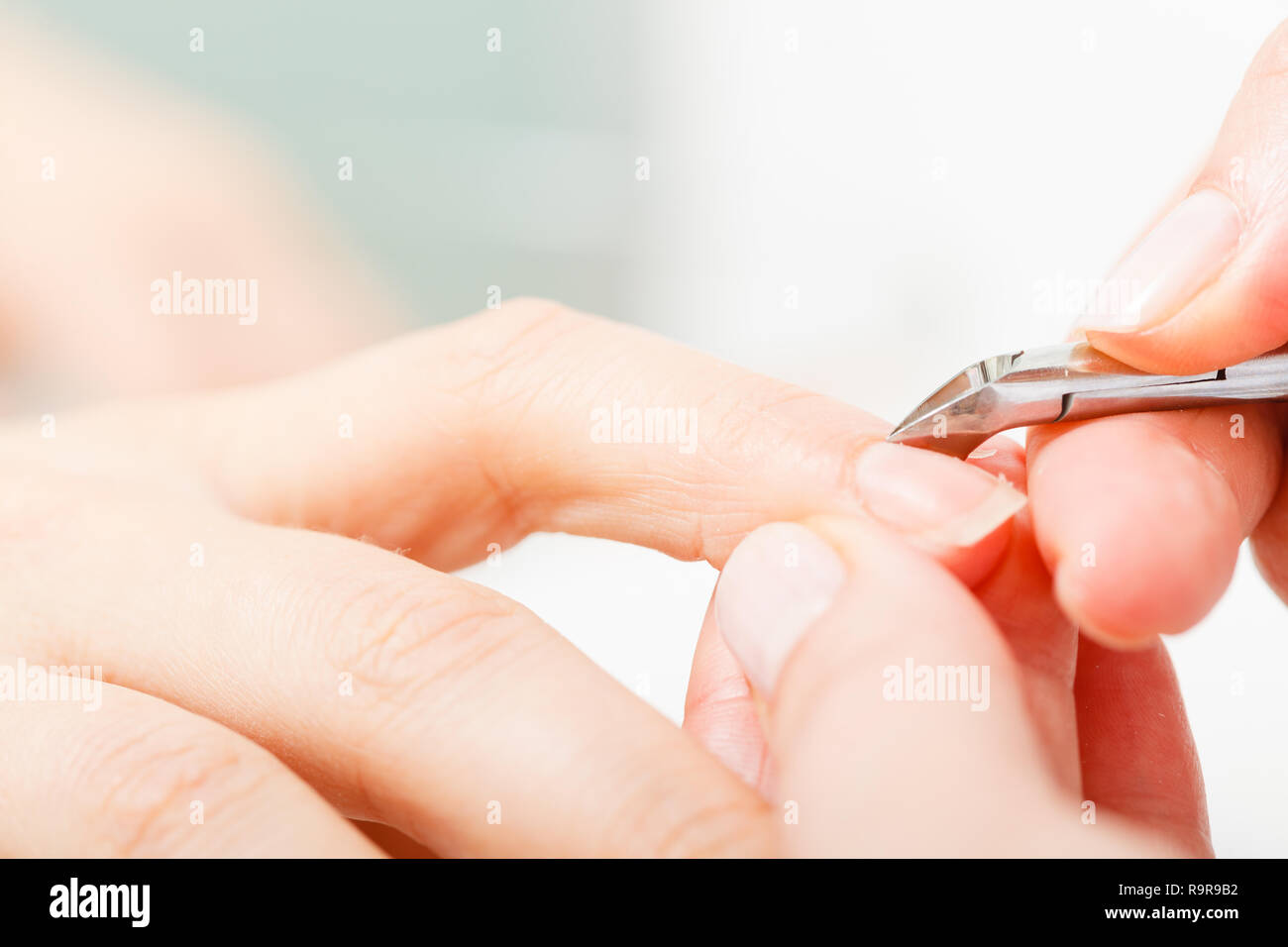 Nail care, beauty wellness spa treatment concept. Woman preparing nails before manicure, cutting