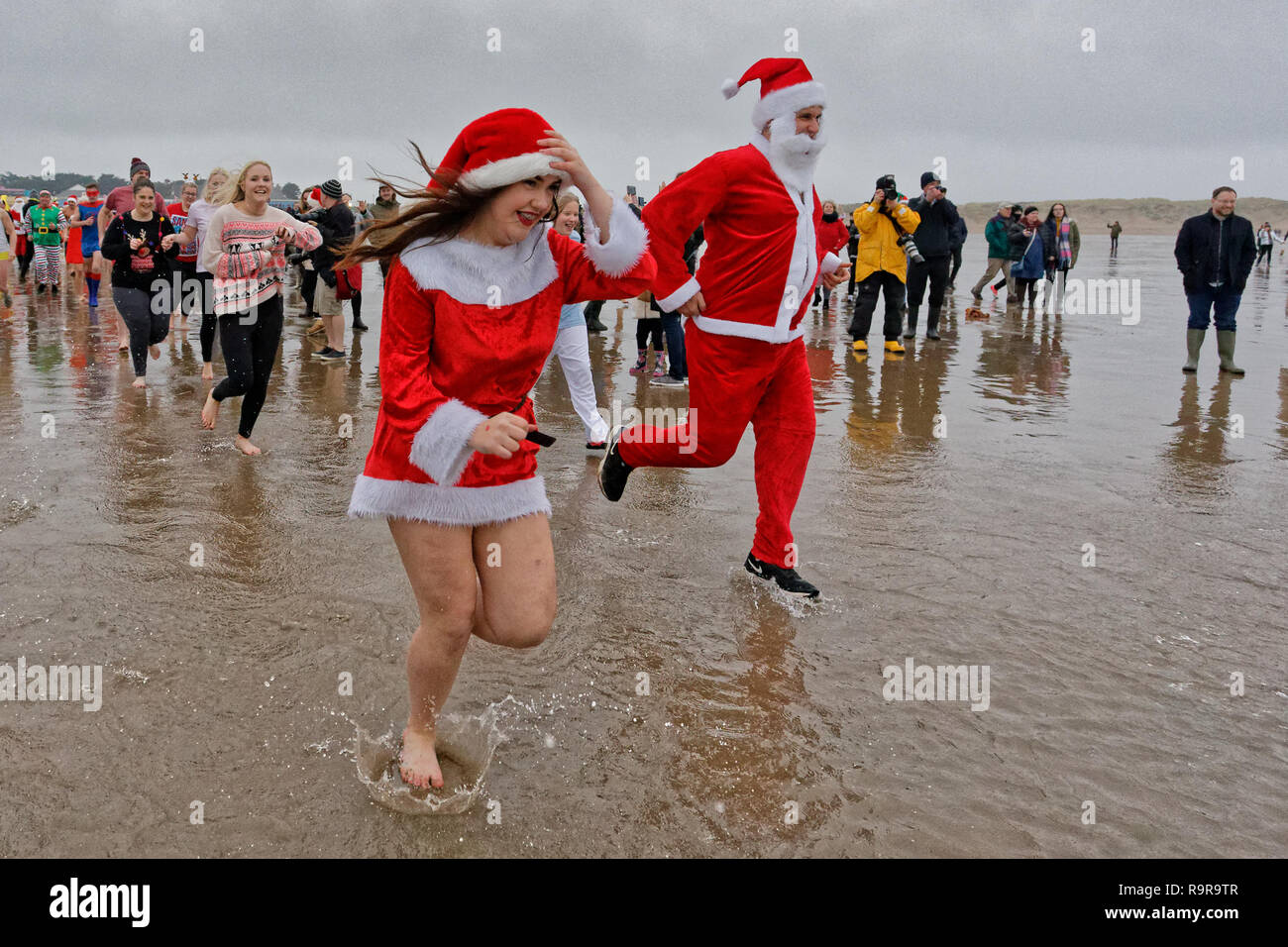 Pictured: People in festive fancy dress costumes run to the freezing cold see. Tuesday 25 December 2018 Re: Hundreds of people take part in this year' Stock Photo