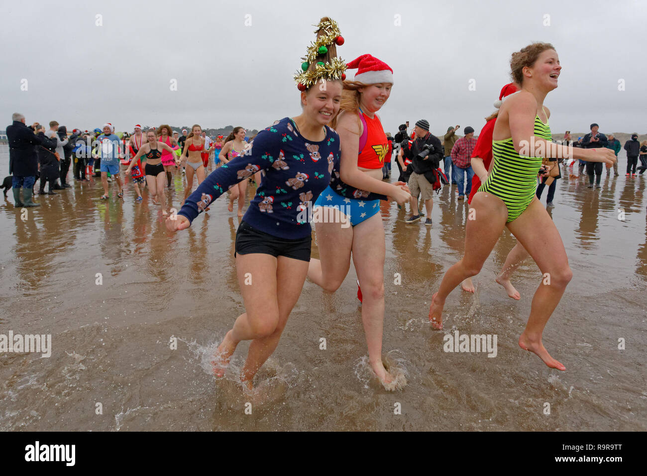 Pictured: People in festive fancy dress costumes run to the freezing cold see. Tuesday 25 December 2018 Re: Hundreds of people take part in this year' Stock Photo