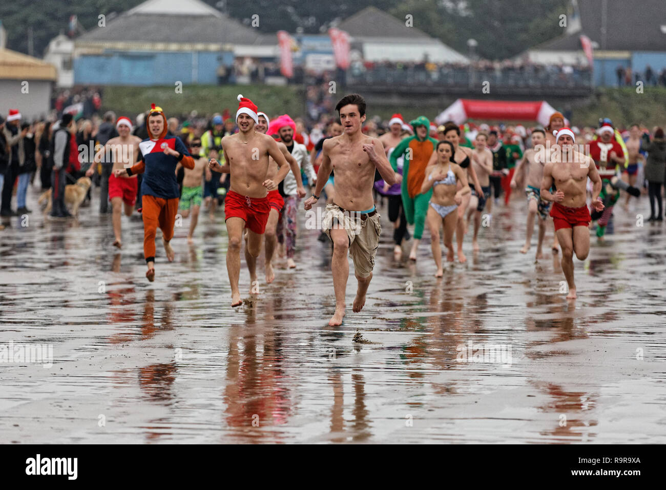 Pictured: People in festive fancy dress costumes run to the freezing cold see. Tuesday 25 December 2018 Re: Hundreds of people take part in this year' Stock Photo