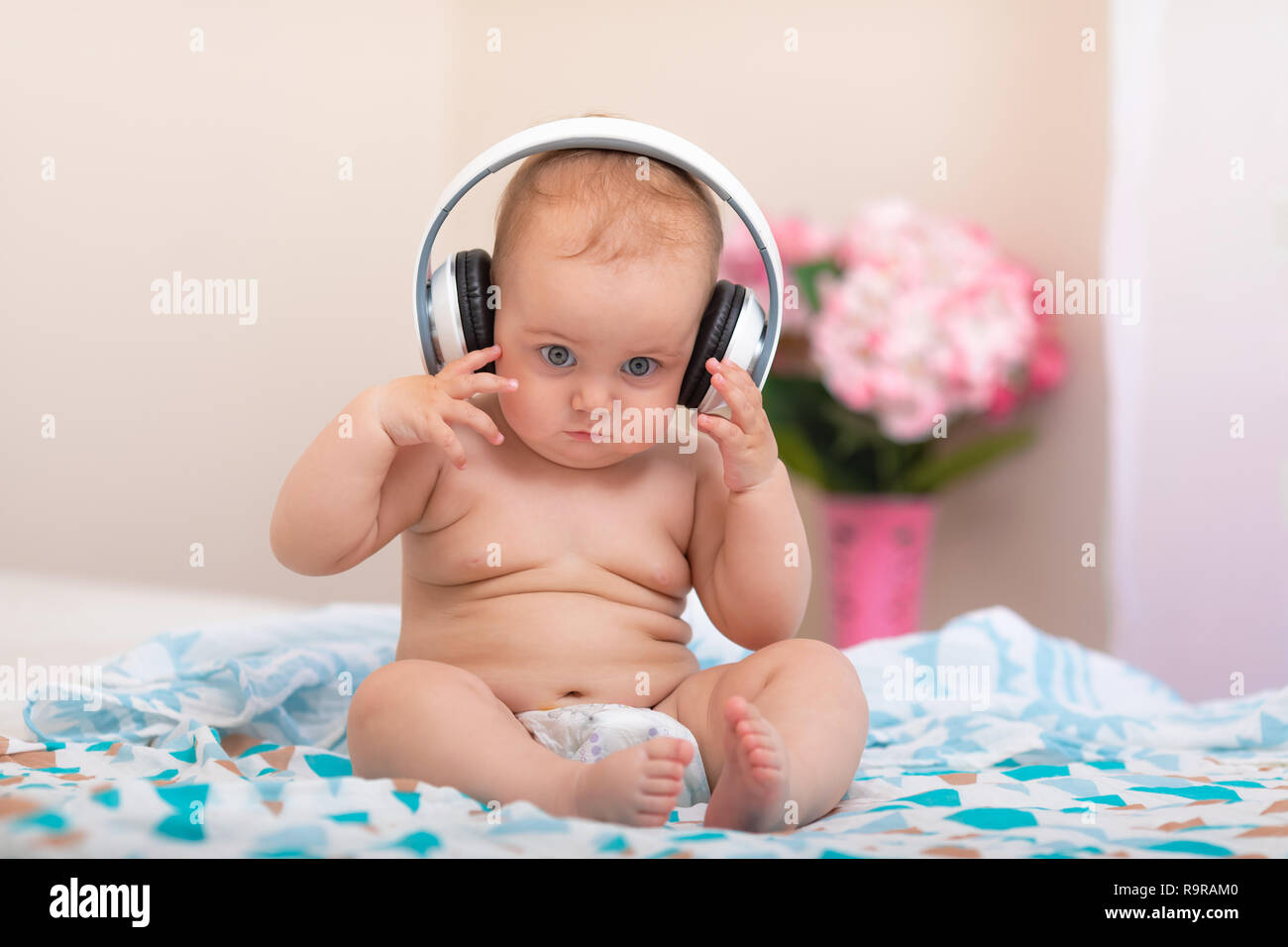 baby sitting in bed Stock Photo