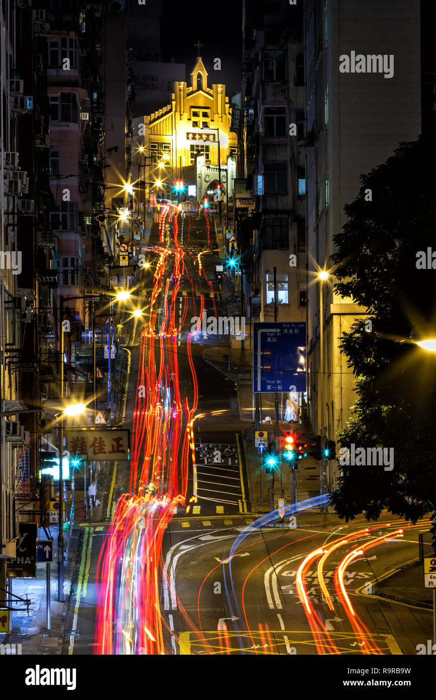 Western Street, Hong Kong  - December 26, 2018 :  Light tracks in the high density city. Western Street is an uphill one-way street in Sai Ying Pun. Stock Photo