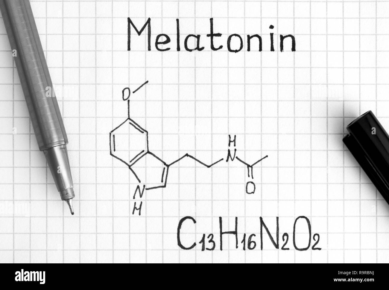 Chemical formula of Melatonin with black pen. Close-up. Stock Photo