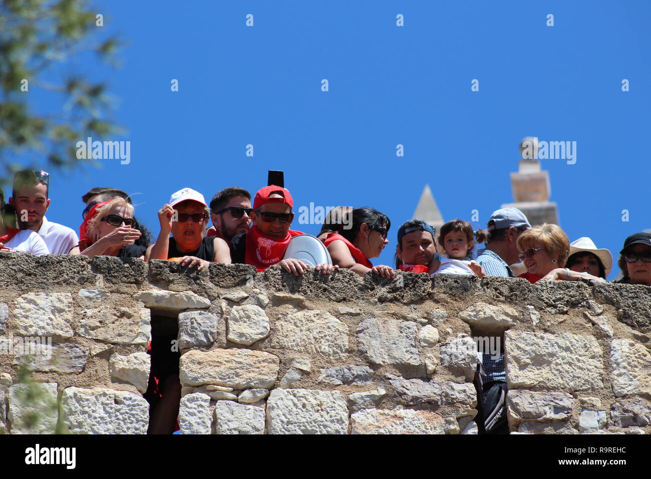 Spectators watching the Los Caballos Del Vino in Caravaca de la Cruz from the wall of the cathedral. Stock Photo