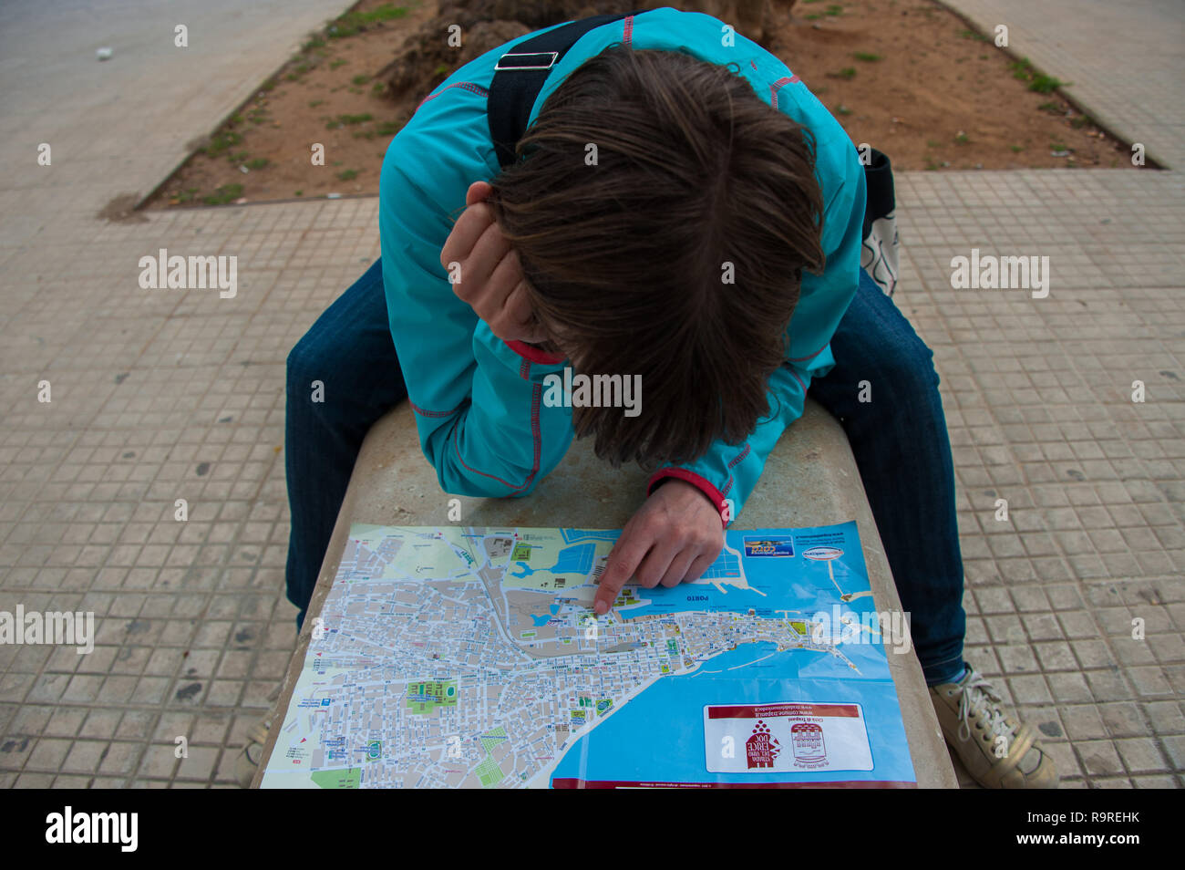 Woman reading map in a street of Sicily, Italy Stock Photo