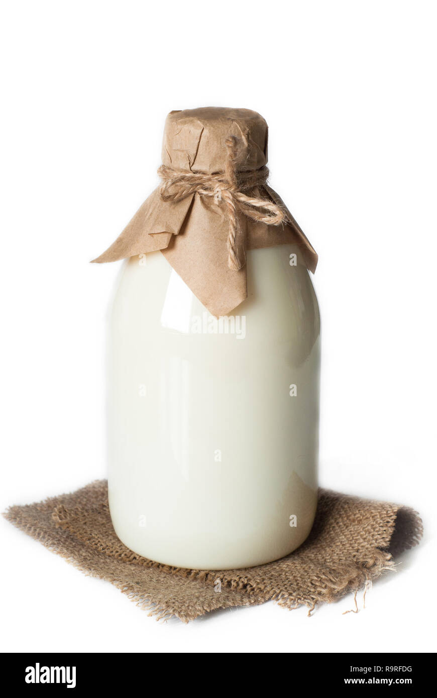 Old fashioned Bottle with milk isolated on white. Stock Photo