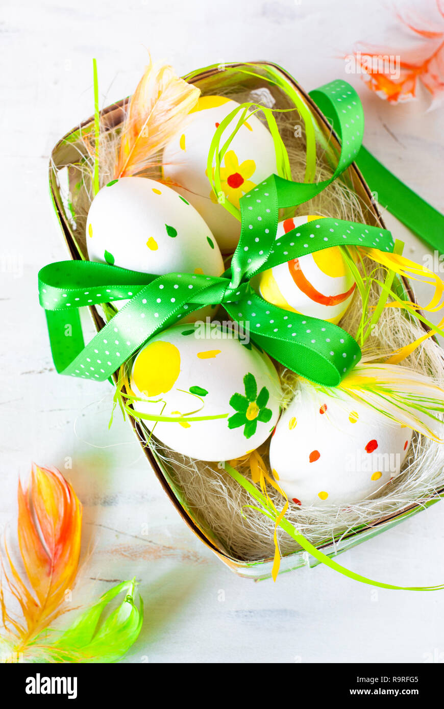 Handcrafted Easter eggs in the nest on white background. View from ...