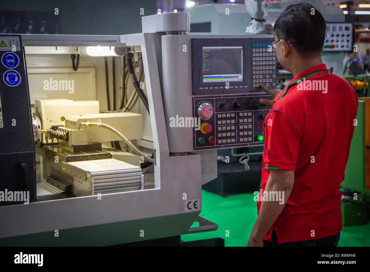 Worker input data for programing CNC machine Stock Photo - Alamy