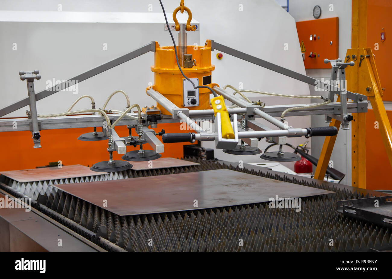 Mechanical vacuum metal sheet lifter loading to production line Stock