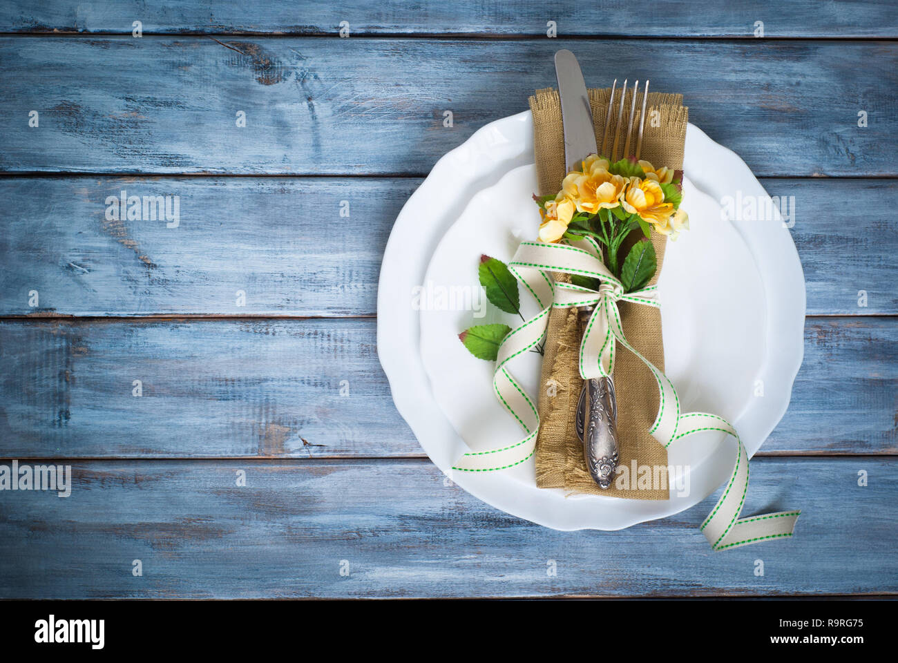 Spring Table setting with white plate and vintage silverware at wooden ...
