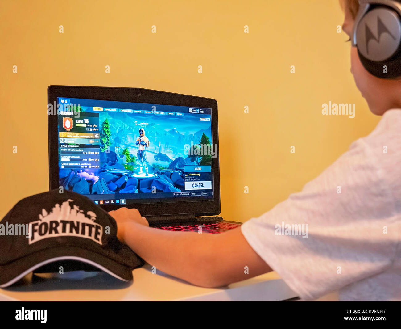 Boy playing Fortnite. Fortnite is online video game developed by Epic Games Stock Photo