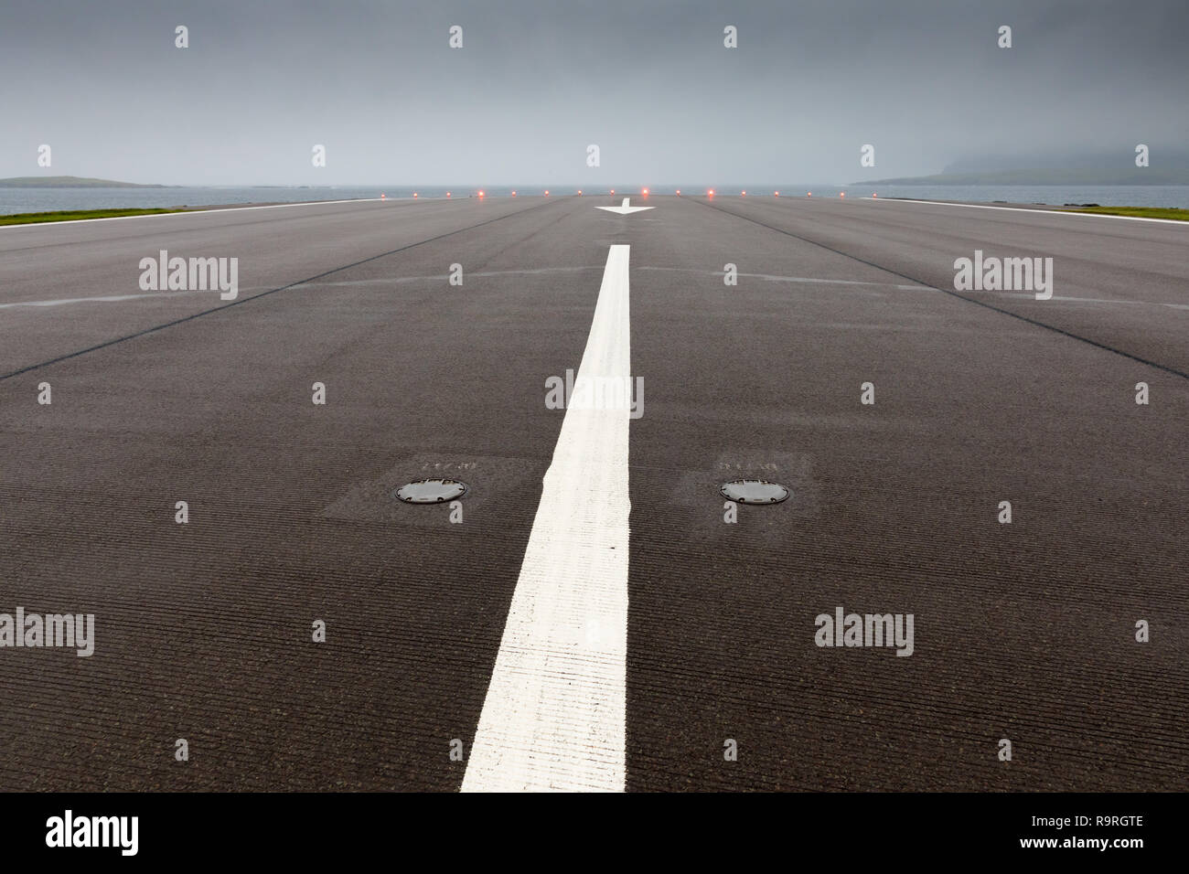 Road crossing airstrip of Sumburgh Airport, Shetland Stock Photo