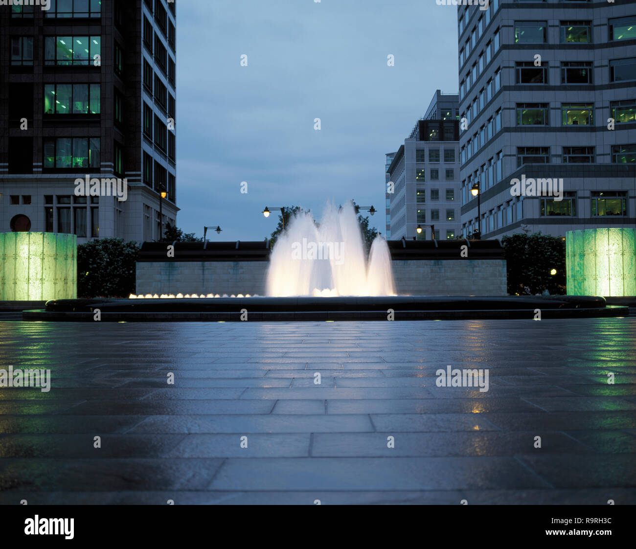 Illuminated fountain in a city at dusk Stock Photo - Alamy