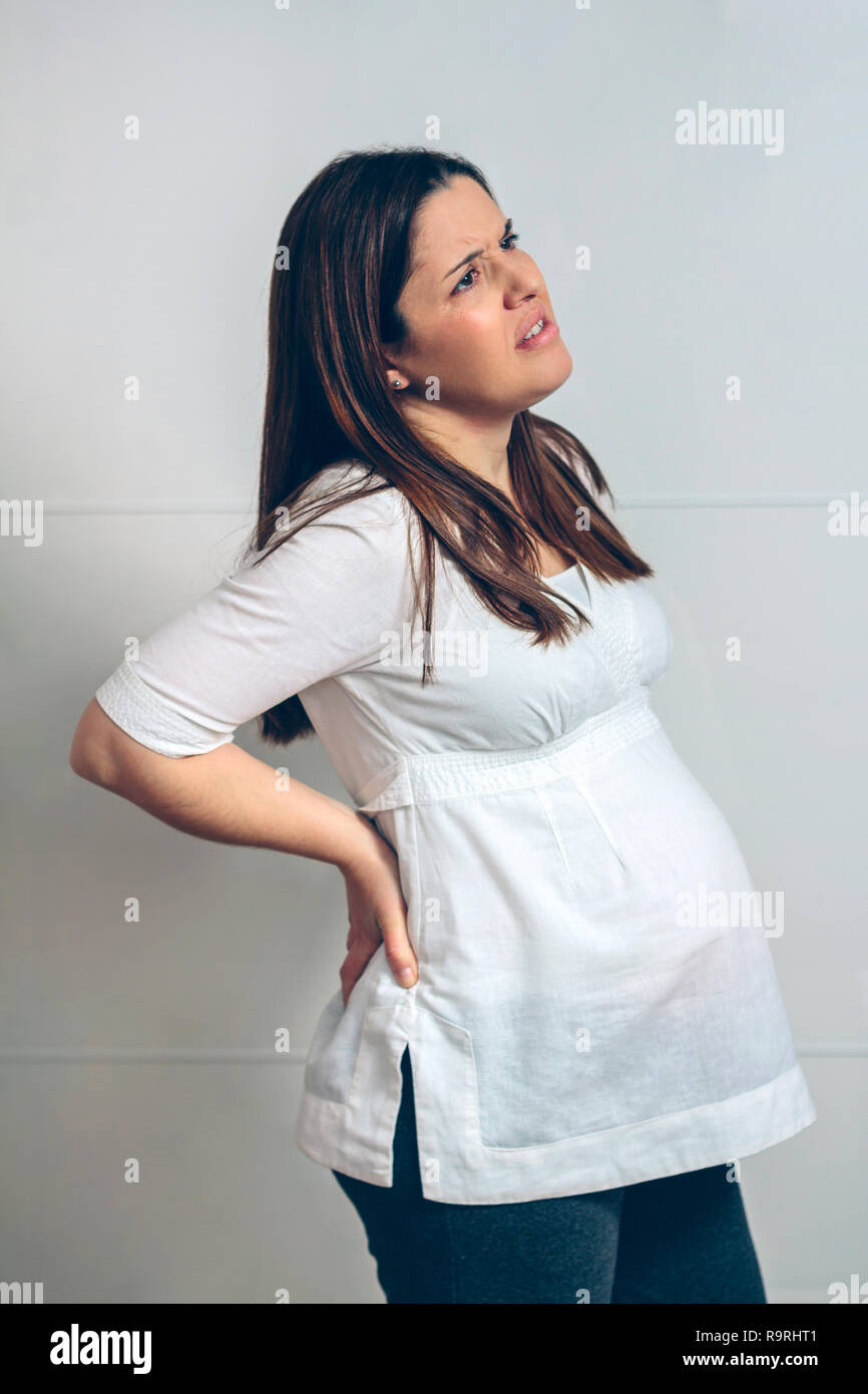 Pregnant woman with spine pain touching her back Stock Photo Alamy