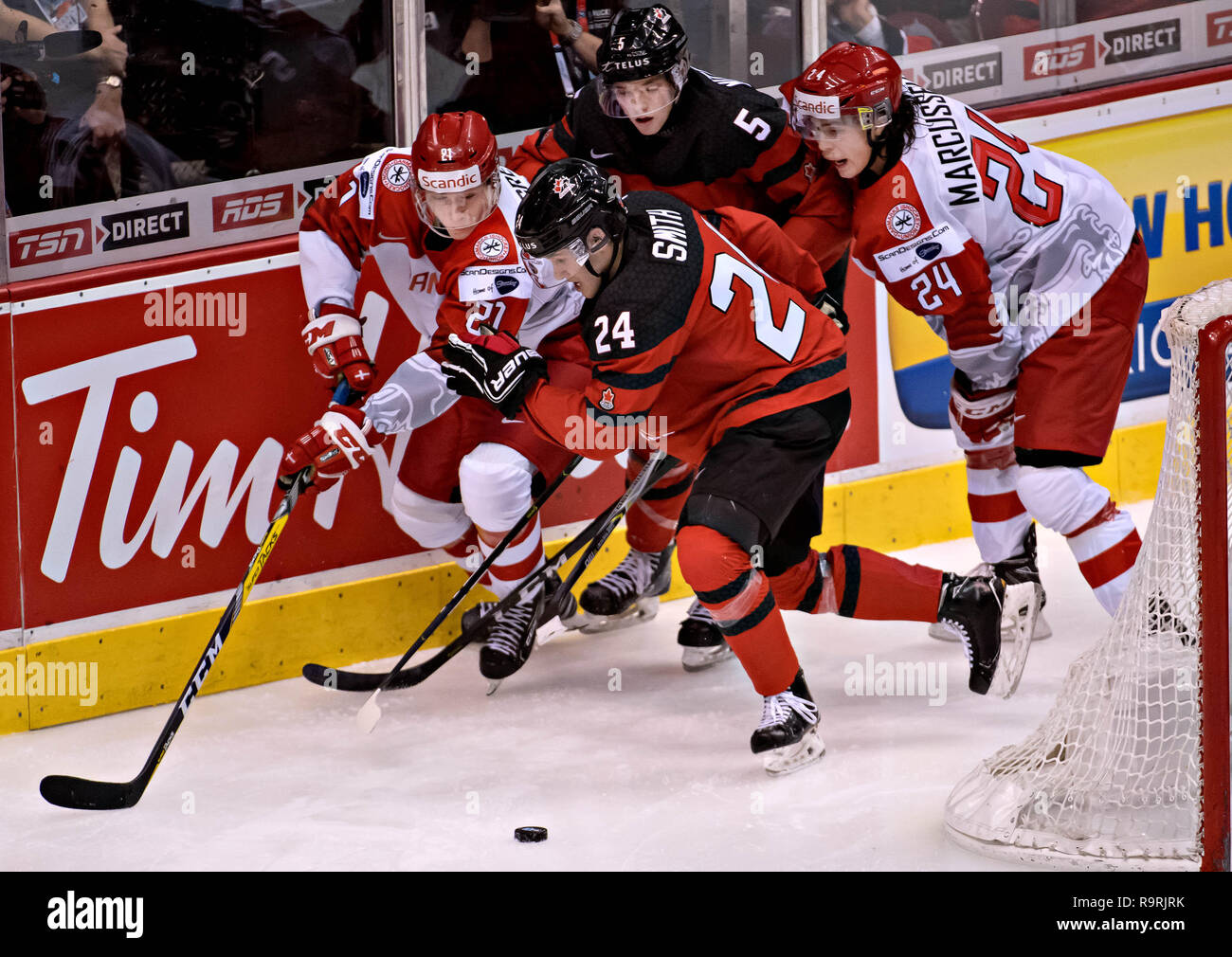 Vancouver. 26th Dec, 2018. Denmark's Gustav Green (1st L) and Canada's Ty Smith (2nd L) compete during the IIHF World Junior Championships in Vancouver, Dec. 26, 2018. Canada won the preliminary match 14-0. Credit: Andrew Soong/Xinhua/Alamy Live News Stock Photo
