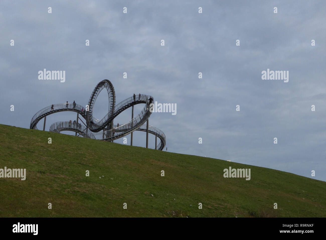 December 27, 2018 - Duisburg, North Rhine-Westphalia, Germany - People can be seen walking on the 'Tiger and Turtle ''“ Magic Mountain' art installation in Angerpark, Duisburg, Germany. Designed by ULRICH GENTH and HEIKE MUTTER in 2011, it is 21 meters tall, made out of tin, zinc and steel. It resembles a roller coaster but is completely walkable, except for the loop. Credit: Jan Scheunert/ZUMA Wire/Alamy Live News Stock Photo