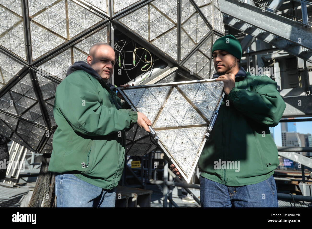 New York, USA. 27th Dec 2018. Landmark Signs workers install 192 new Waterford Crystal triangles, featuring this year's 'Gift of Harmony' design, on the Times Square New Year's Eve Ball on December 27, 2018 in New York. Credit: Erik Pendzich/Alamy Live News Stock Photo