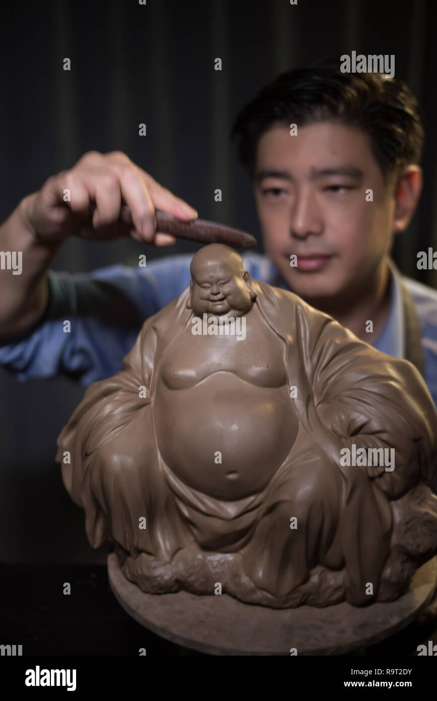 (181229) -- BEIJING, Dec. 29, 2018 (Xinhua) -- Zhang Yu, the sixth generation maker of "Clay Figure Zhang", kneads a figurine at his workshop in Tianjin, north China, Sept. 12, 2017. "Clay Figure Zhang" is a household name of traditional folk art in China, and such artwork has a history of nearly 200 years. Zhang Yu, the sixth generation clay figurine maker in his family, took charge of the family business in 1996, when he was just 18 years old.     As time changed, the craft and brand has evolved. Instead of making figurines and selling them like a street vendor, he has hired art managers to  Stock Photo