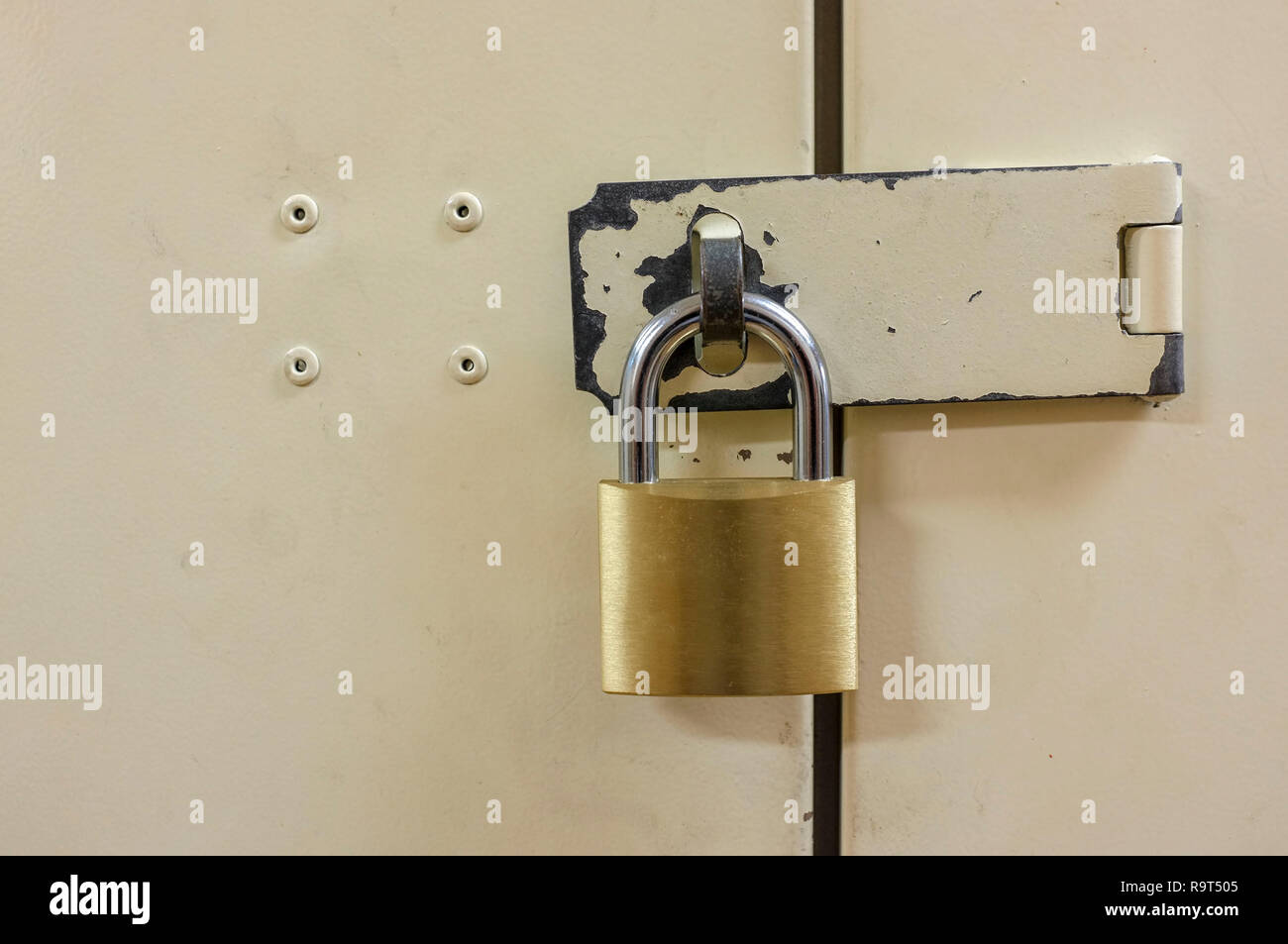 Padlock on closed metal door. Stock Photo