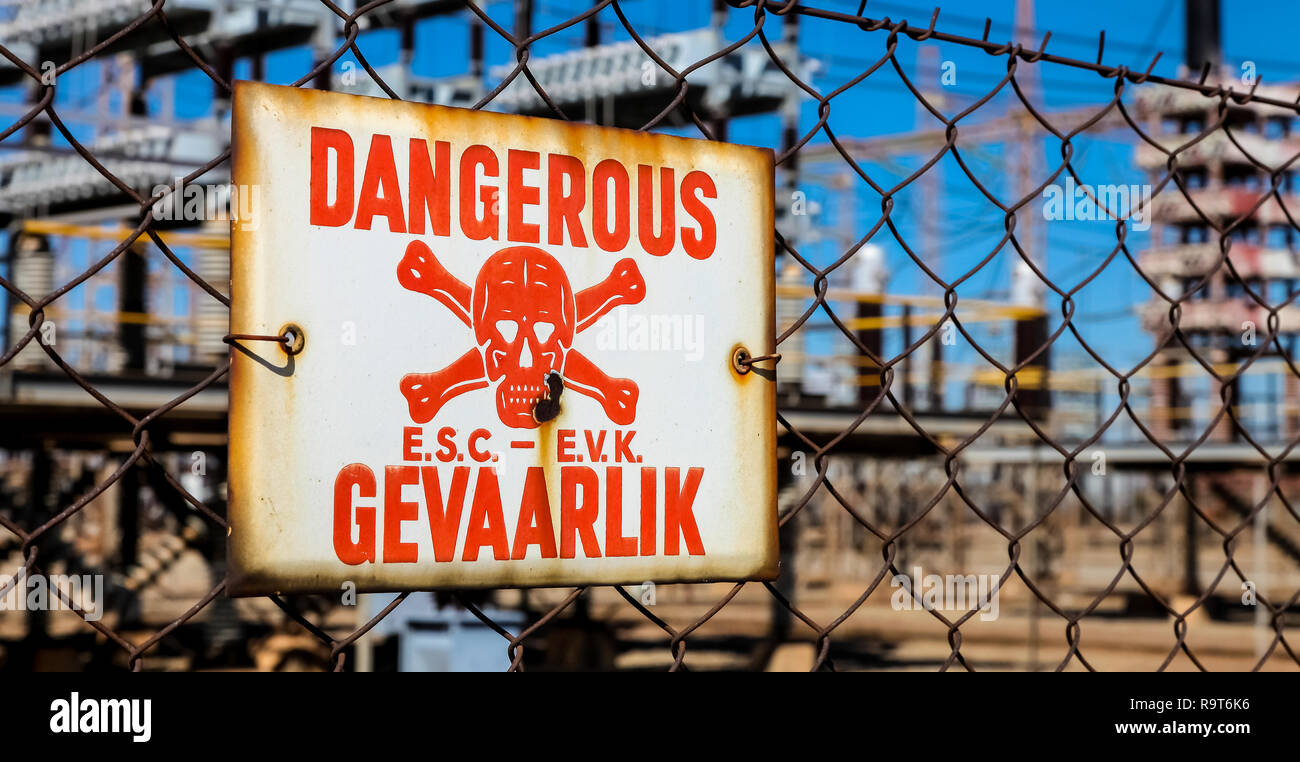 Danger Sign on a fence in English and Afrikaans language Stock Photo