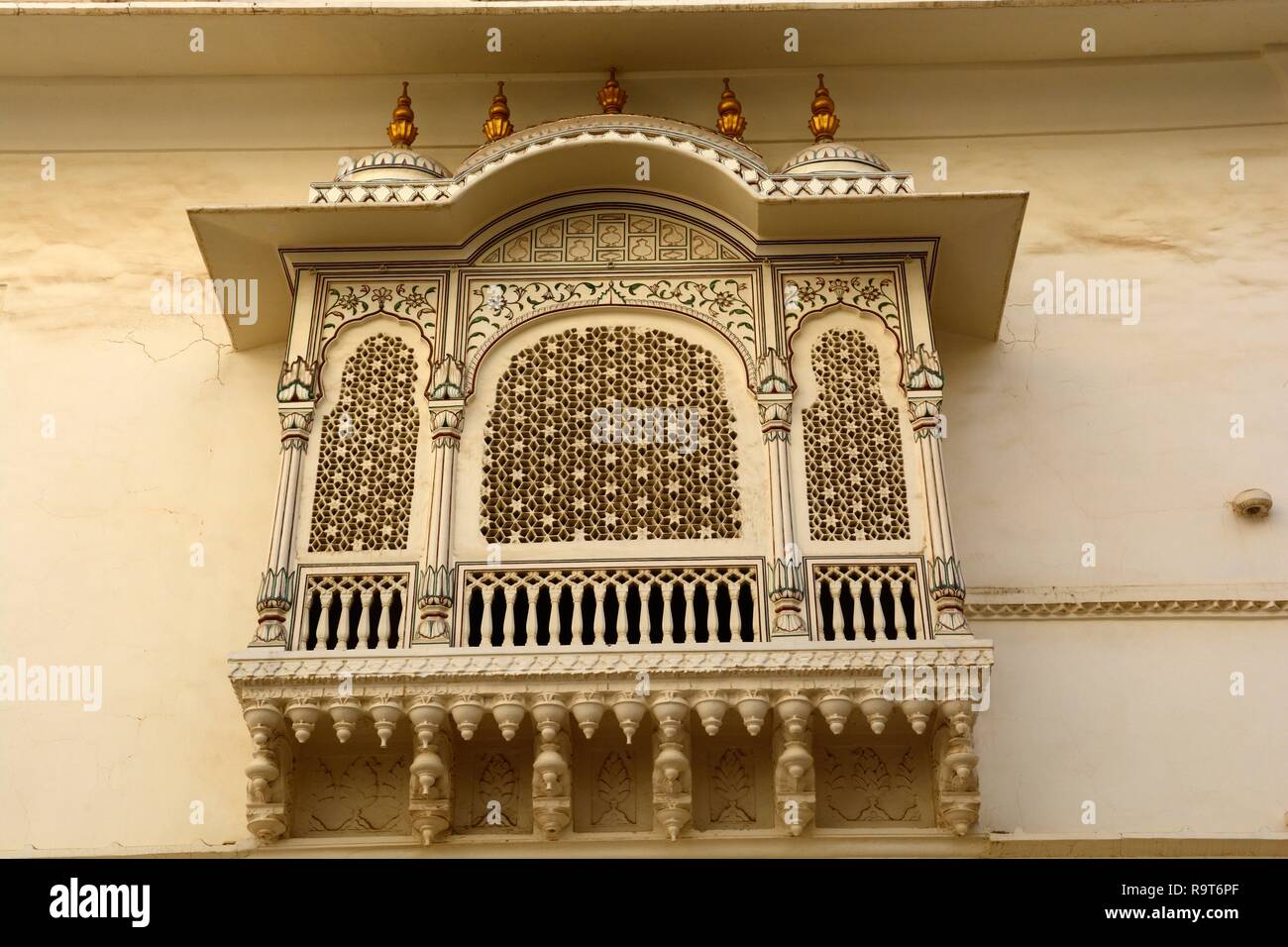 Ornately carved stone window or Jharokha overhanging balcony Harem window to allow women to see but not be seen Junagarh Fort Bikaner Rajashan India Stock Photo