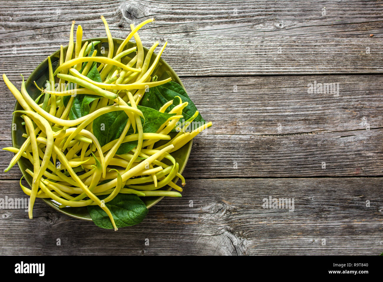 Yellow bean, organic farm fresh beans on plate, vegan food, cooking concept Stock Photo