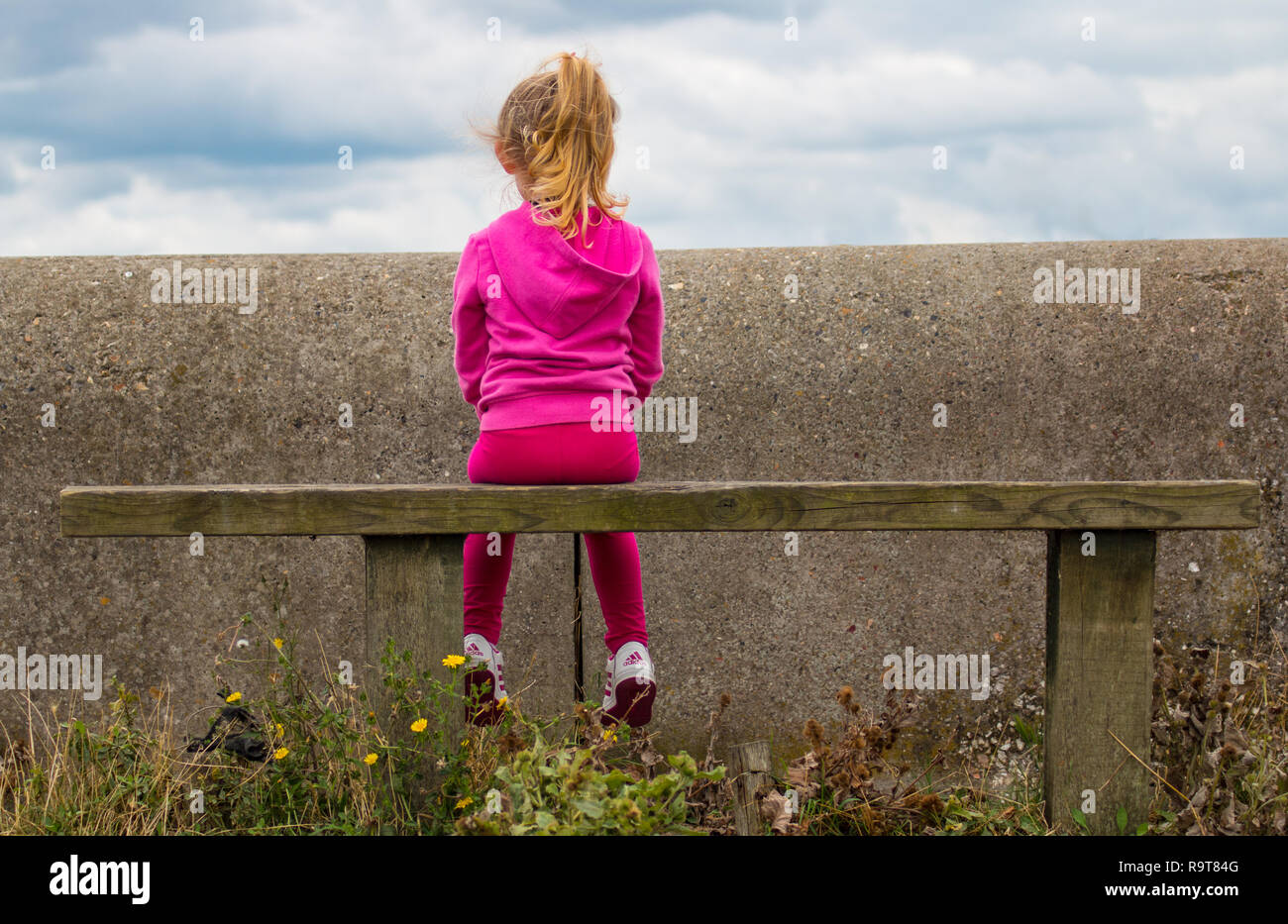 Girl sitting on bench hi-res stock photography and images - Alamy