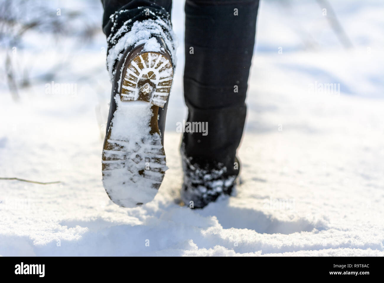 Foot In Boot Female feet in boots in snow walking in winter Stock Photo - Alamy