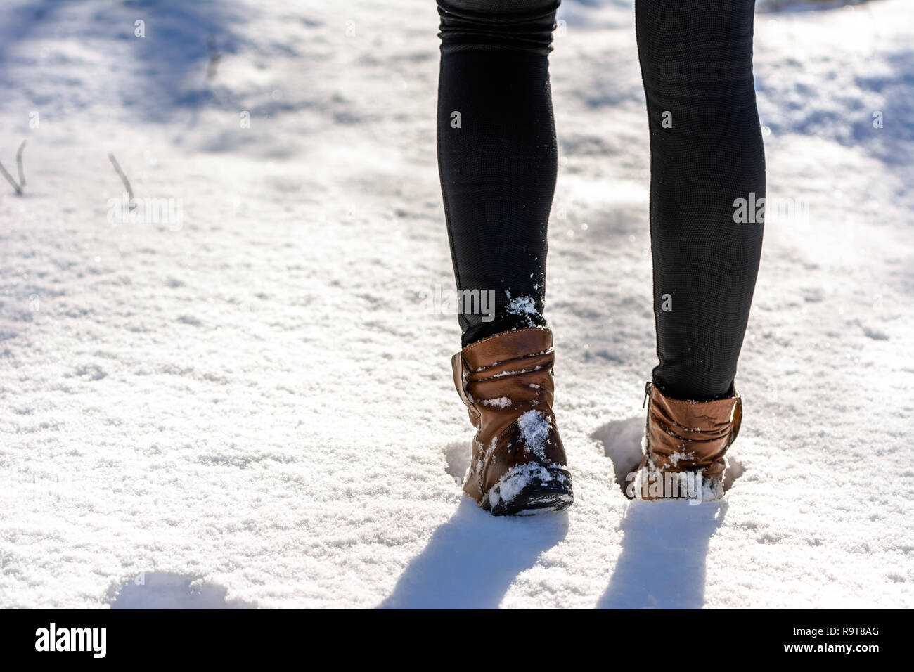 Woman in snow boots and leggings on legs, women's winter shoes