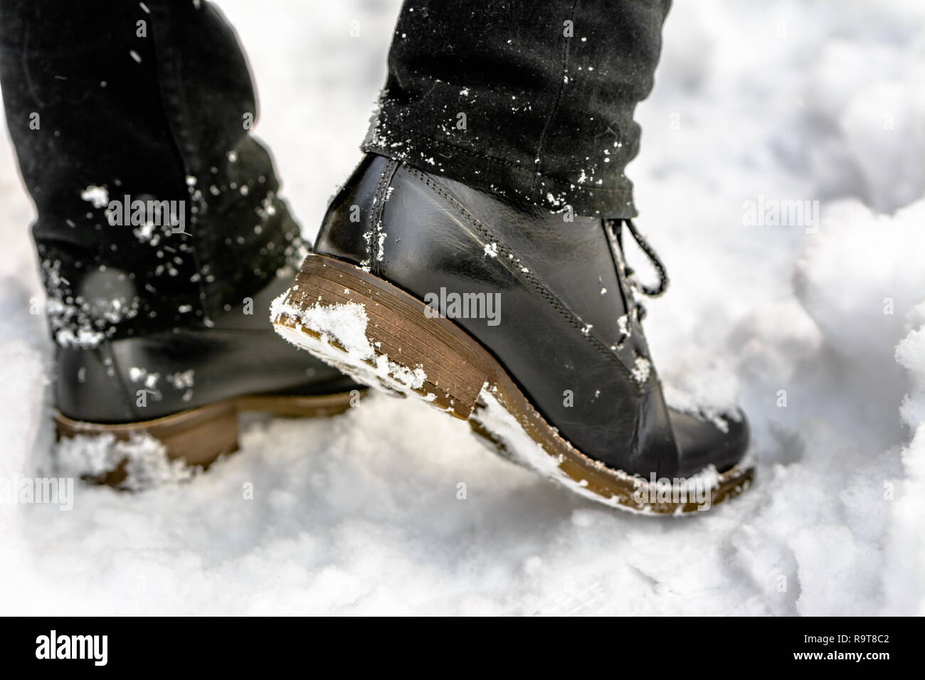 Fashionable mens boots in snow, feet in the black shoes, winter fashion  Stock Photo - Alamy