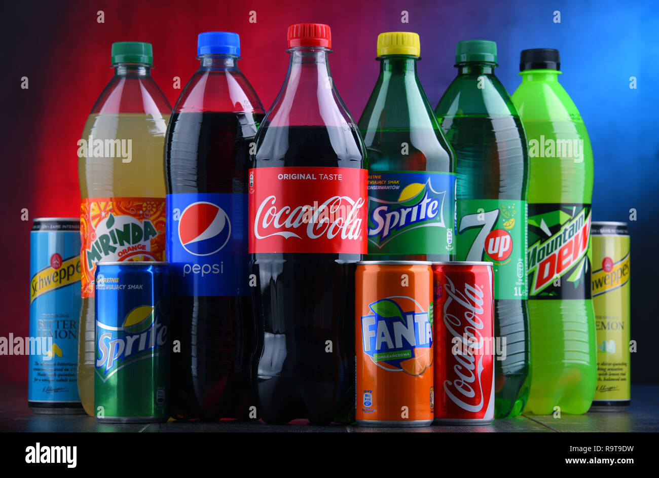 POZNAN, POLAND - NOV 16, 2018: Bottles and cans of global soft drink brands including products of Coca Cola Company and Pepsico Stock Photo