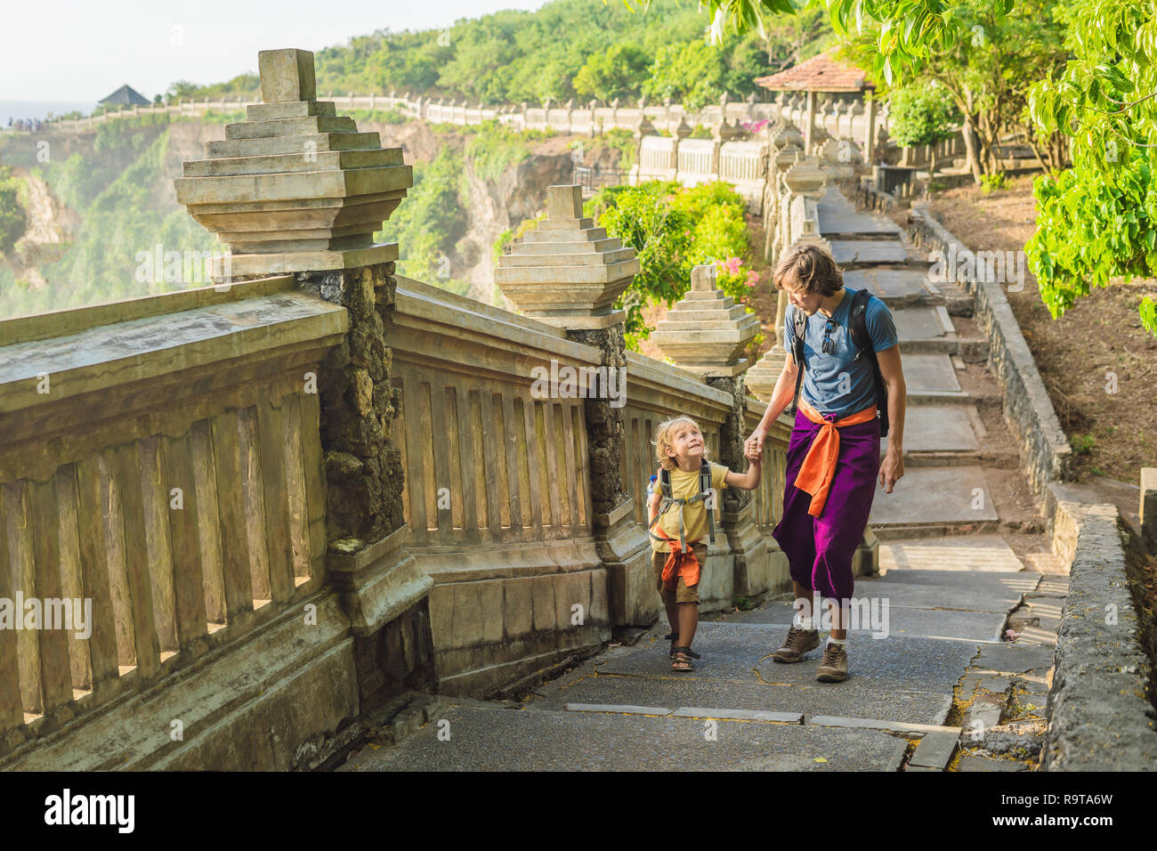 Dad and son travelers in Pura Luhur Uluwatu temple, Bali, Indonesia.  Amazing landscape - cliff with blue sky and sea. Traveling with kids  concept Stock Photo - Alamy