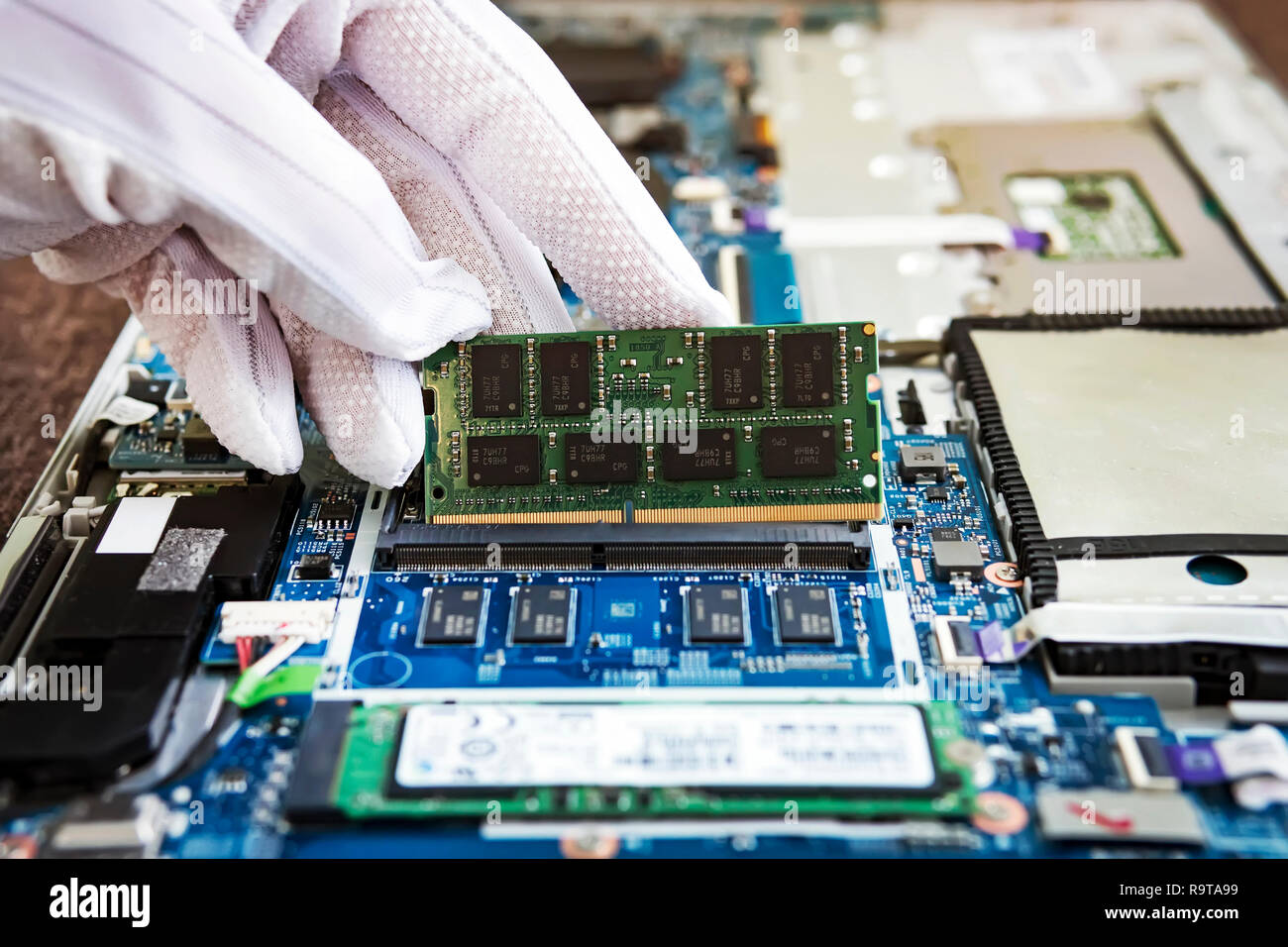 Random access memory for replacement to laptop computer. RAM module DDR in  hand on the background of a modern notebook-transformer. ultrabook upgrade  Stock Photo - Alamy