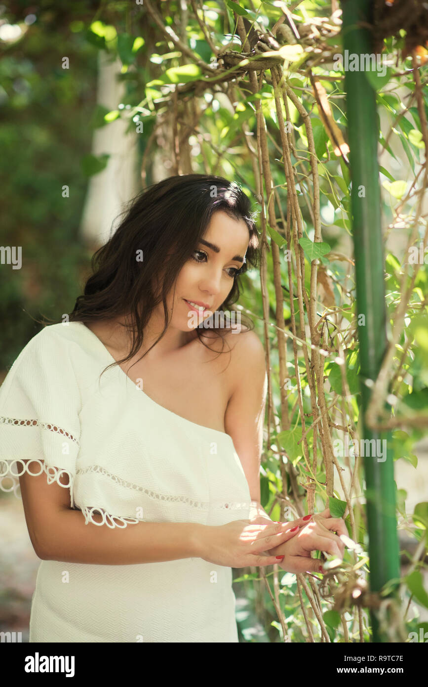 Happy young woman standing outdoors smiling Stock Photo