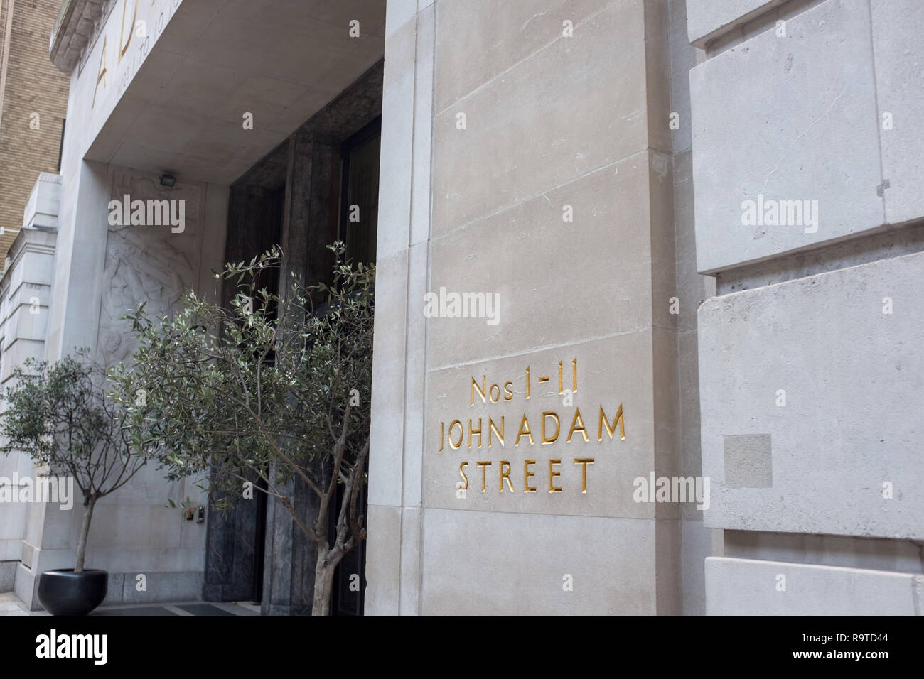 The letters 1-11 John Adam Street mark the entrance to the Adelphi, a 1930 art deco building in London that was restored by architects Aukett Swanke Stock Photo